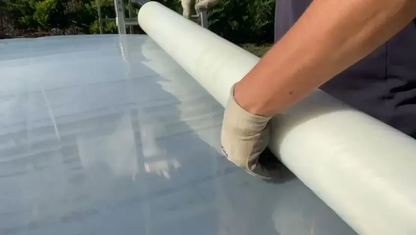 Greenhouse structures in warm light, from the presentation film